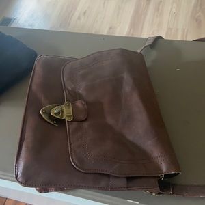 Cross body purse with gold detailing.